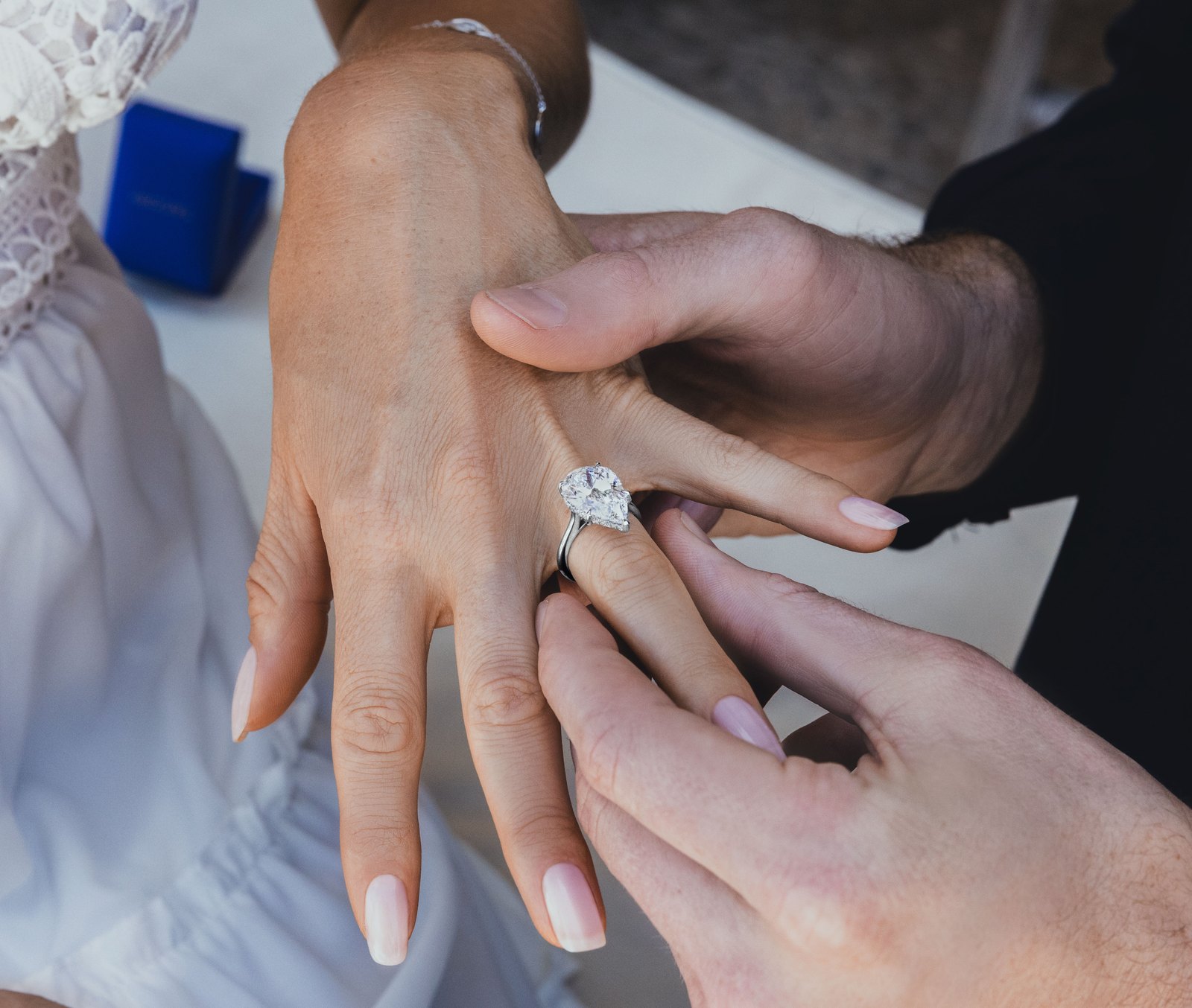 A couple wearing their engagement ring and wedding bands